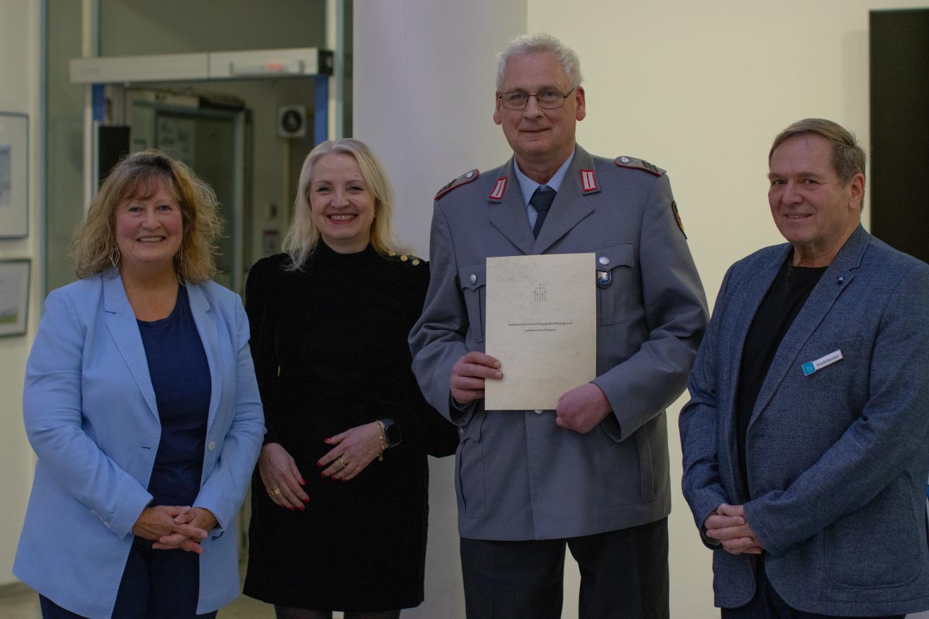 Zu sehen ist Michael Czernoch mit 3 weiteren Personen, wie er eine Ehrenurkunde in der Hand hält.